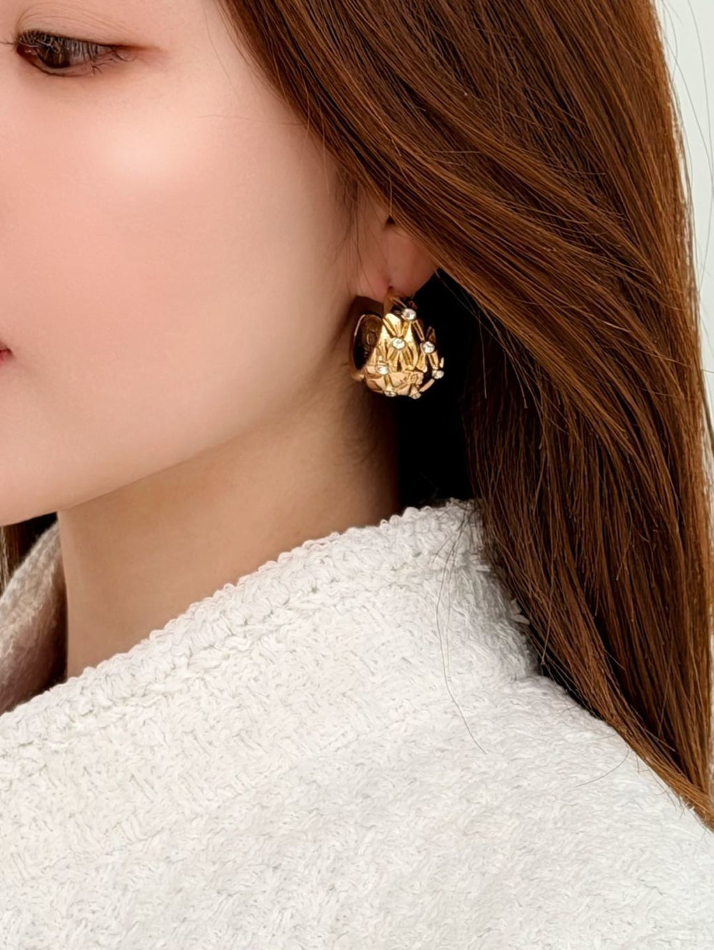 Diamond-encrusted gold earrings.