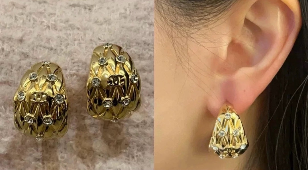 Diamond-encrusted gold earrings.