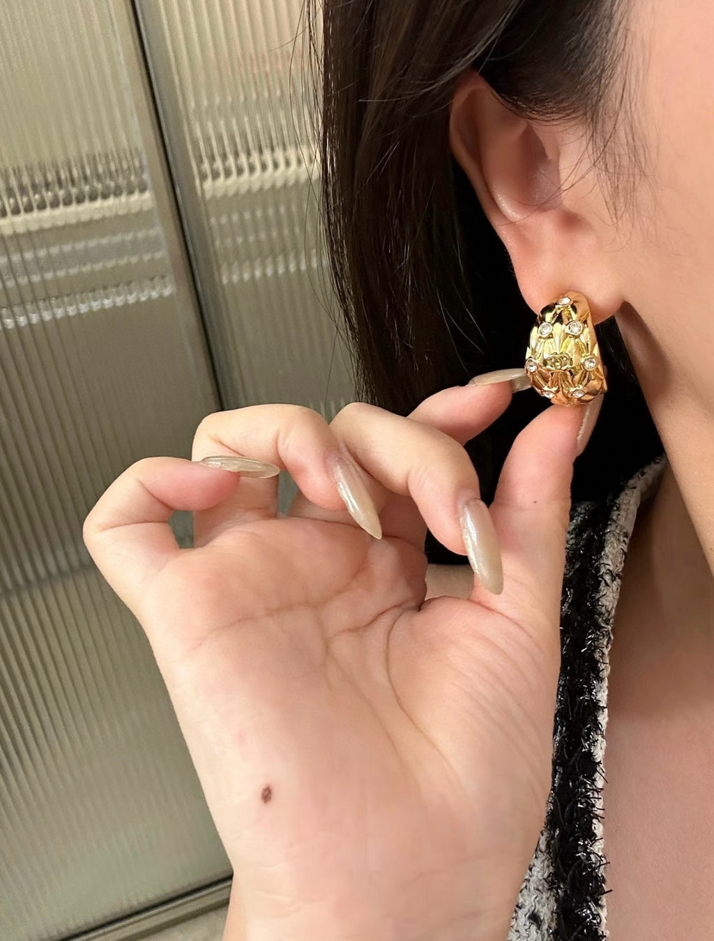 Diamond-encrusted gold earrings.