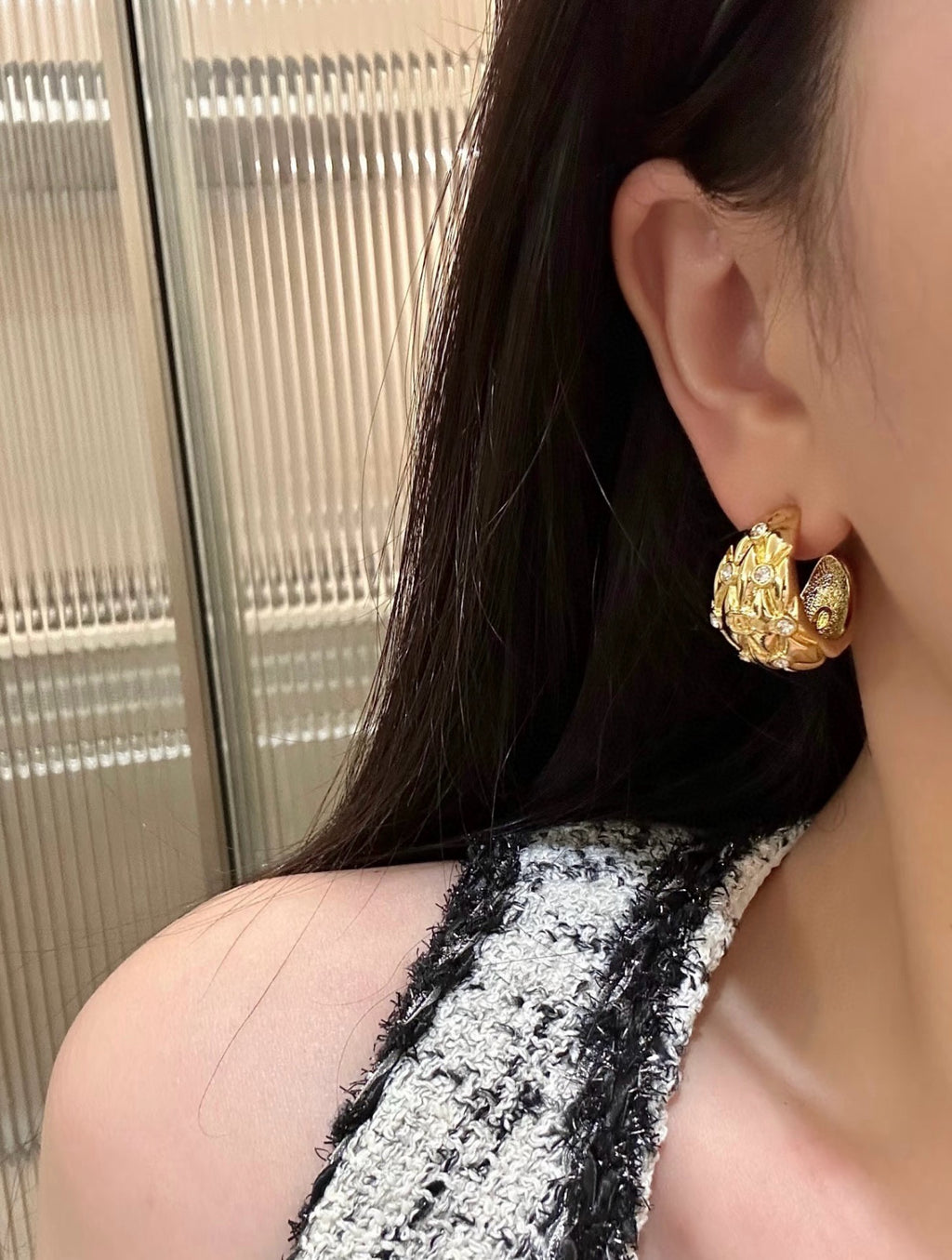 Diamond-encrusted gold earrings.