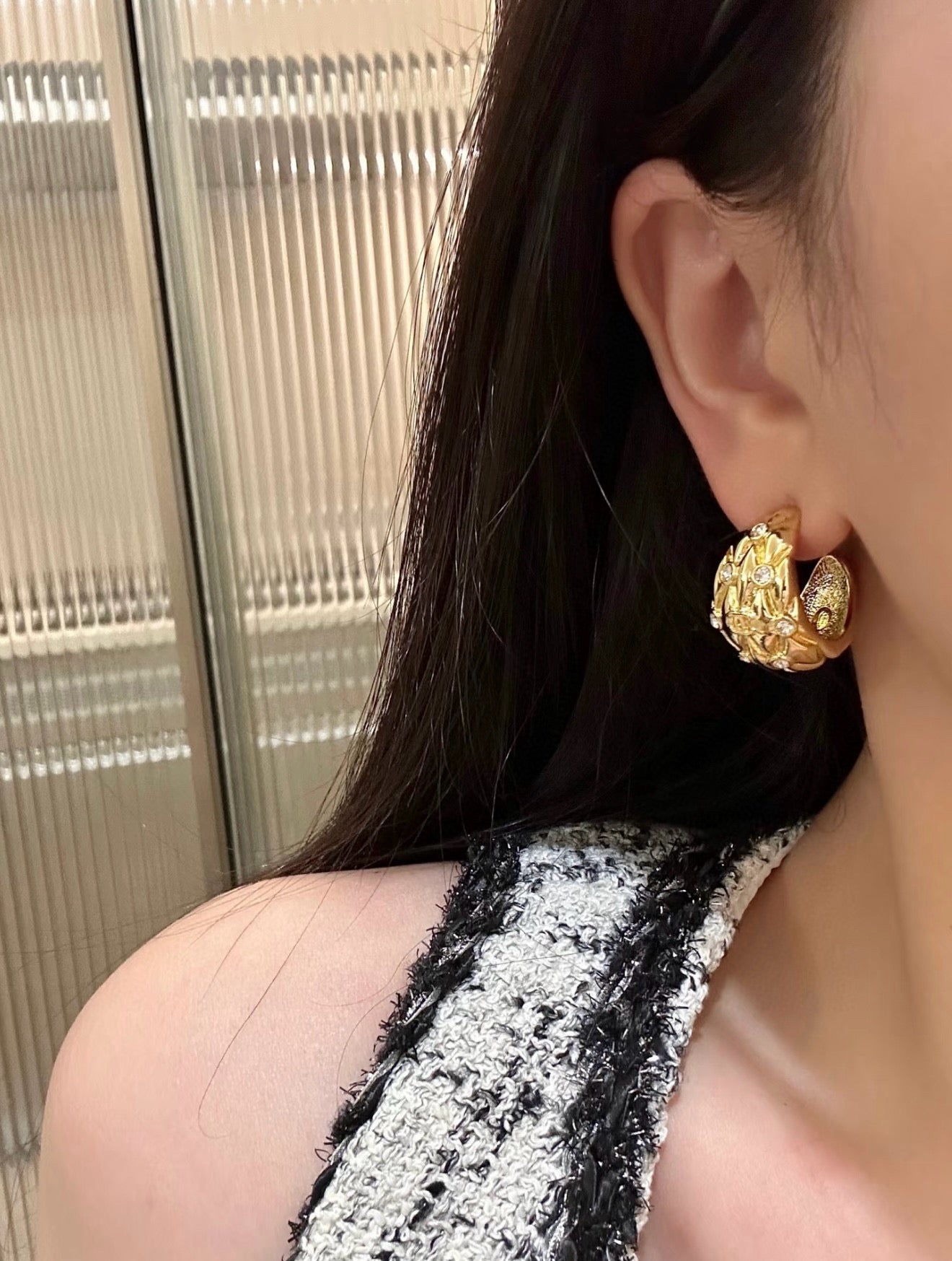 Diamond-encrusted gold earrings.