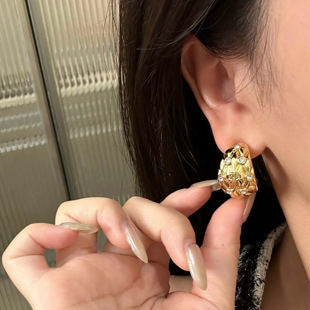 Diamond-encrusted gold earrings.